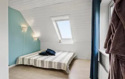 a small bedroom with a bed in a attic at 3 Bedroom Beautiful Home In Vesløs in Vesløs