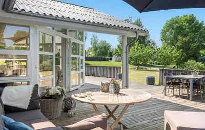 a patio with a table and chairs and an umbrella at Pet Friendly Home In Farsø With Wifi in Farsø