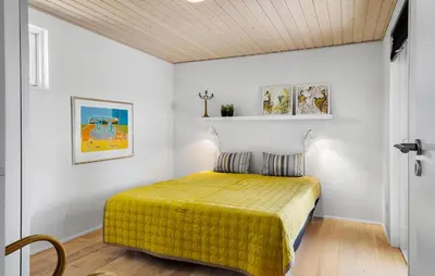 a bedroom with a bed with a yellow bedspread at Pet Friendly Home In Farsø With Wifi in Farsø