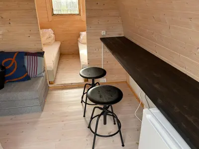 a room with two stools in a tiny house at Camping Vesterhav in Harboør