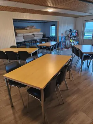 a classroom with tables and chairs in a room at Camping Vesterhav in Harboør