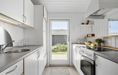 a white kitchen with a sink and a window at Stunning Home In Harboøre With Wifi in Harboør