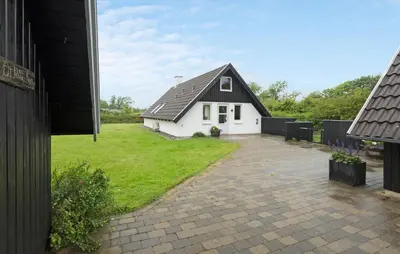 a small white house with a black roof at Beautiful Home In Spøttrup With Kitchen in Spottrup