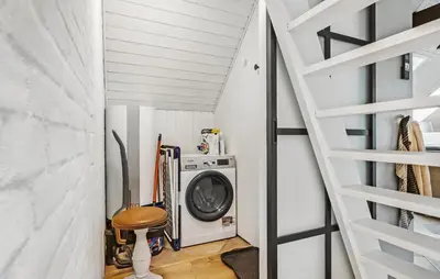 a laundry room with a washing machine and a staircase at Beautiful Home In Spøttrup With Kitchen in Spottrup