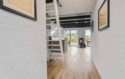 a living room with a ladder and a fireplace at Beautiful Home In Spøttrup With Kitchen in Spottrup