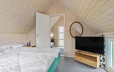 a bedroom with a bed and a flat screen tv at Beautiful Home In Spøttrup With Kitchen in Spottrup