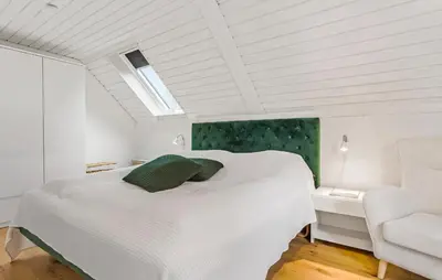 a white bedroom with a bed and a chair at Beautiful Home In Spøttrup With Kitchen in Spottrup