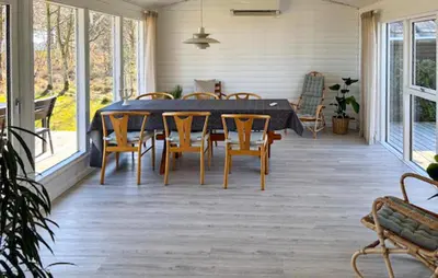 a screened porch with a table and chairs on it at Amazing Home In Højslev With Wifi in Højslev