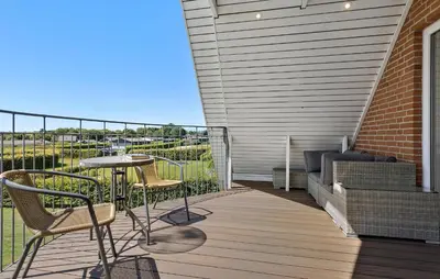 a patio with a table and chairs on a deck at Gorgeous Home In Øster Assels With Wifi in Øster Assels