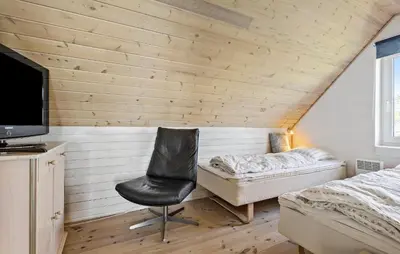 a bedroom with a bed and a chair in a room at Gorgeous Home In Øster Assels With Wifi in Øster Assels