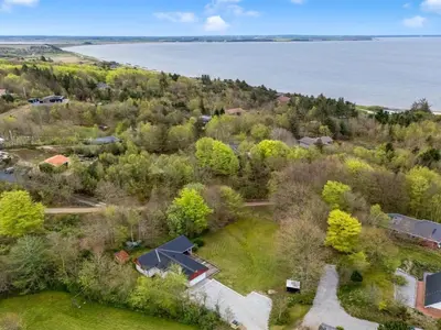 an aerial view of a house and the water at Holiday Home Dwerg - 300m to the fjord by Interhome in Lihme