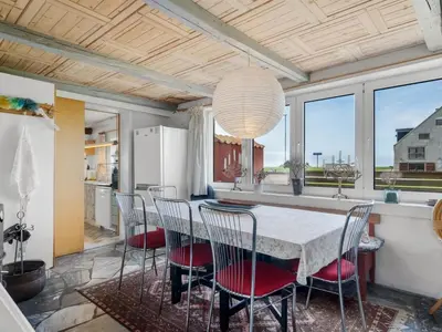 a kitchen and dining room with a table and chairs at Holiday Home Edvardsine - 20m to the fjord by Interhome in Vestervig