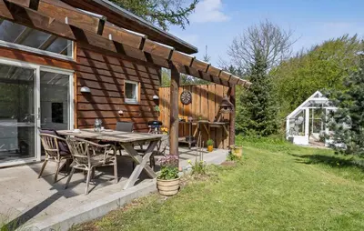 a wooden cabin with a table and chairs in the yard at Stunning Home In Bedsted Thy With Wifi in Bedsted Thy