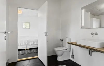 a bathroom with a toilet and a sink and a bed at Stunning Home In Bedsted Thy With Wifi in Bedsted Thy