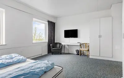 a bedroom with a bed and a desk and a television at 11 Bedroom Gorgeous Home In Hurup Thy in Hurup