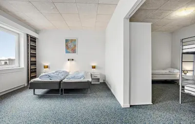 a white room with two beds and a window at 11 Bedroom Gorgeous Home In Hurup Thy in Hurup