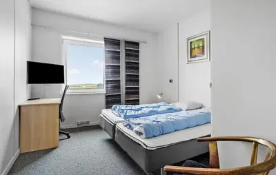 a bedroom with a bed and a desk and a television at 11 Bedroom Gorgeous Home In Hurup Thy in Hurup