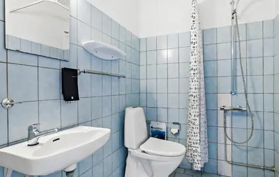 a bathroom with a toilet and a sink and a shower at 11 Bedroom Gorgeous Home In Hurup Thy in Hurup