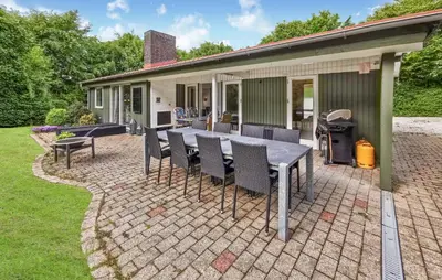 a patio with a table and chairs in front of a house at Cozy Home In Spøttrup With Wifi in Spottrup