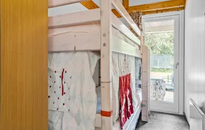 a bunk bed in a tiny house with a window at Cozy Home In Spøttrup With Wifi in Spottrup