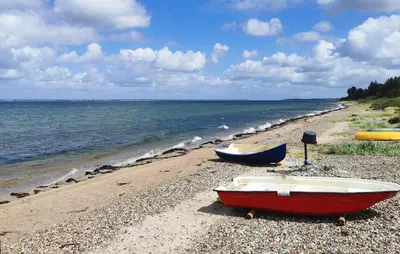 two boats sitting on a beach near the water at Cozy Home In Spøttrup With Wifi in Spottrup