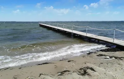 a wooden pier in the ocean with waves at Cozy Home In Spøttrup With Wifi in Spottrup