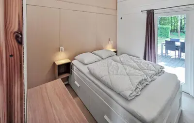 a bedroom with a large bed with a window at Cozy Home In Spøttrup With Wifi in Spottrup