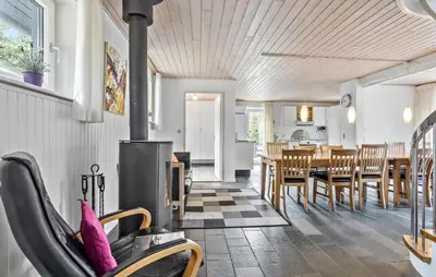 a kitchen and dining room with a wood stove at Stunning Home In Vestervig With Sauna in Vestervig