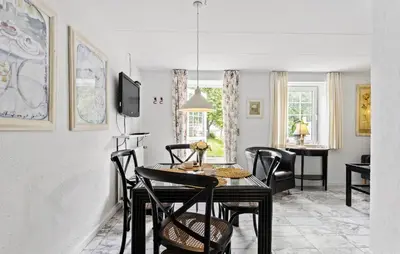 a dining room with a table and chairs at Lejl 4 in Brovst