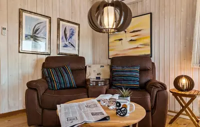 a living room with two chairs and a table at Lovely Home In Thisted With Kitchen in Thisted