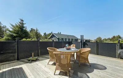 a patio with a table and chairs on a deck at Lovely Home In Thisted With Kitchen in Thisted