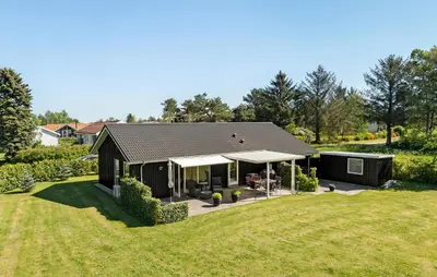a small black house with a large yard at Pet Friendly Home In Farsø With Kitchen in Farsø