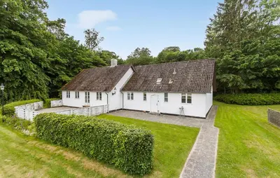 a white house with a large yard at Lejl 1 in Brovst