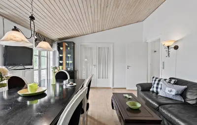 a living room with a table and a couch at Hus 2 in Brovst