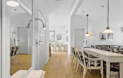 a kitchen and living room with a table and chairs at Hus 1 in Brovst