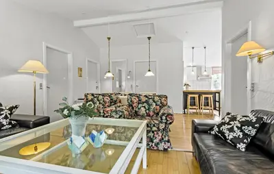 a living room with a couch and a glass table at Hus 1 in Brovst