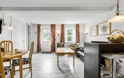a kitchen and living room with a table and chairs at Lejl 7 in Brovst