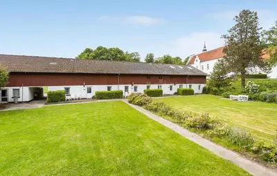 an exterior view of a barn with a large yard at Lejl 2 in Brovst