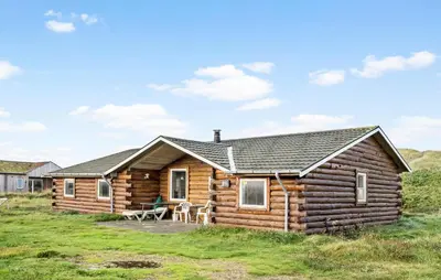 a log cabin with a picnic table in front of it at Gorgeous Home In Harboøre With Kitchen in Harboør