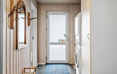 a hallway with a door and a refrigerator at Gorgeous Home In Harboøre With Kitchen in Harboør