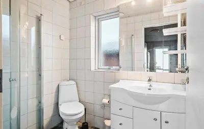 a white bathroom with a toilet and a sink at Gorgeous Home In Harboøre With Kitchen in Harboør