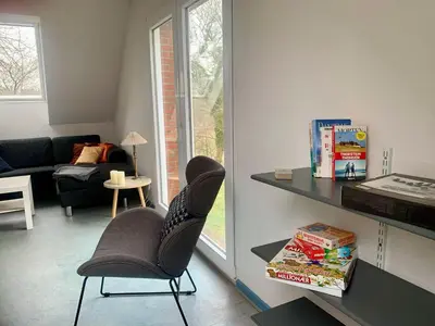 a living room with two chairs and a table at Kongshøjgaard in Farsø
