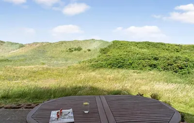 a table with a glass of wine on top of a hill at Cozy Home In Harboøre With Wifi in Harboør