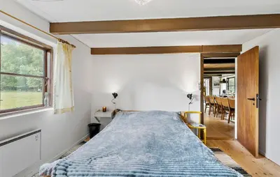a bedroom with a bed in a room with a window at 6 Bedroom Gorgeous Home In Bedsted Thy in Bedsted Thy