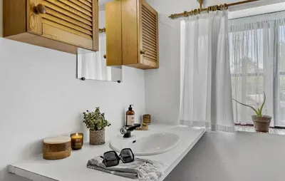 a bathroom sink with a pair of glasses and a window at 6 Bedroom Gorgeous Home In Bedsted Thy in Bedsted Thy