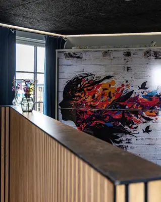 a wall with a painting of a woman on it at Fun Art Blokhus in Blokhus