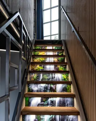 a staircase with a waterfall mural on the stairs at Fun Art Blokhus in Blokhus