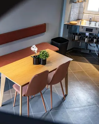 a table in a kitchen with two plants on it at Fun Art Blokhus in Blokhus