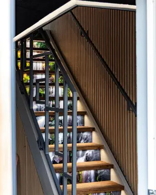 a set of stairs withsteel railings in a building at Fun Art Blokhus in Blokhus