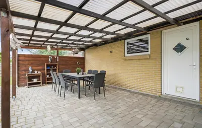 a patio with a wooden pergola and a table and chairs at Amazing Home In Aars With Wifi in Års